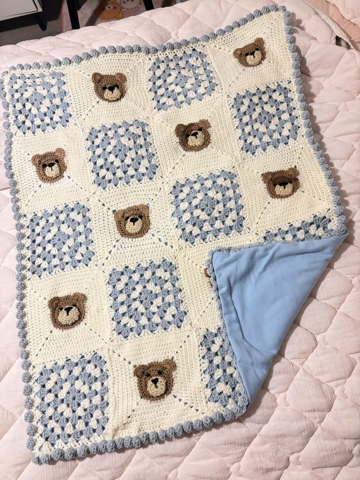 Cream crochet baby blanket with yarn, crochet hook and pattern notebook