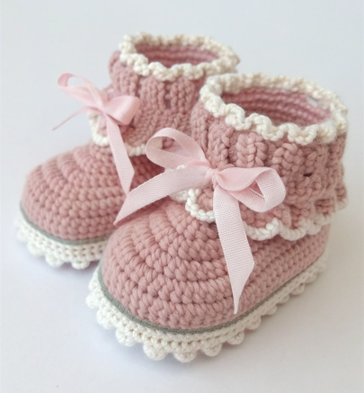 Crochet baby booties in cream and pink yarn