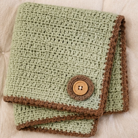 beige crochet baby blanket with rainbow detail